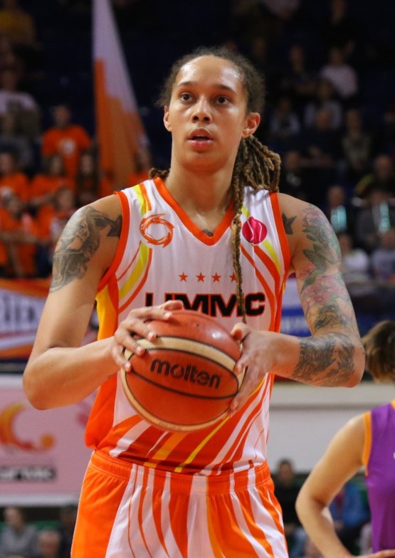 Brittney Griner holding a basketball on court.