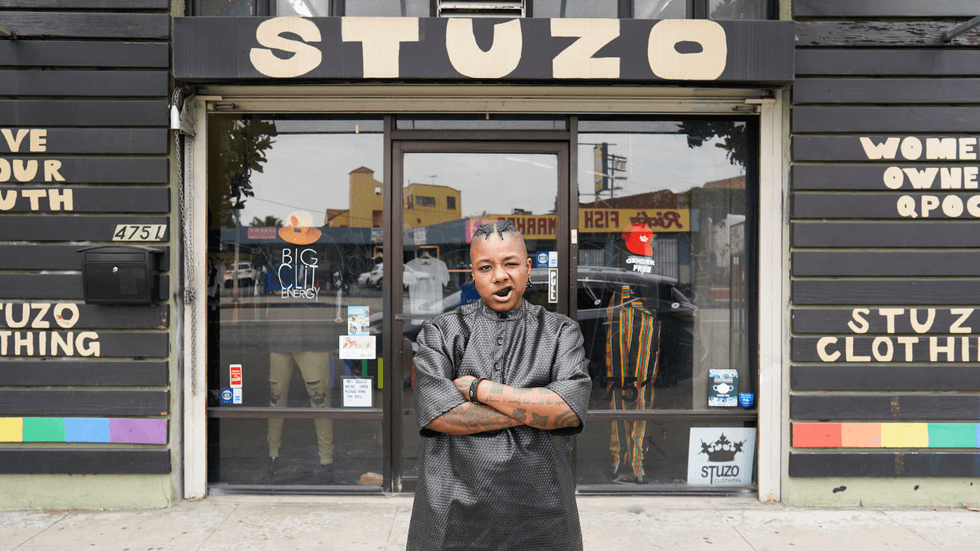Stoney Michelli Love standing in front of the Stuzo Clothing storefront